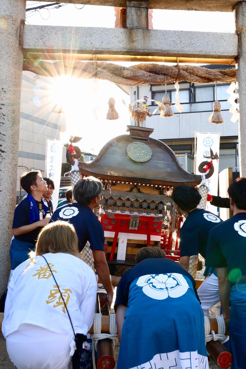 お神輿が鳥居をくぐっている写真