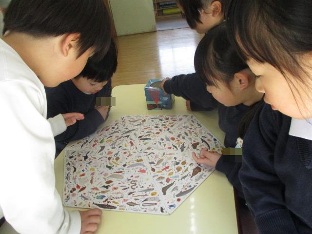年少児が、4月から使う年長組の保育室で『年長ごっこ』をして遊んでいます。絵探しゲームのルールを守って遊んでいます。