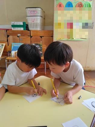 友達が描いている絵をじっと見ている