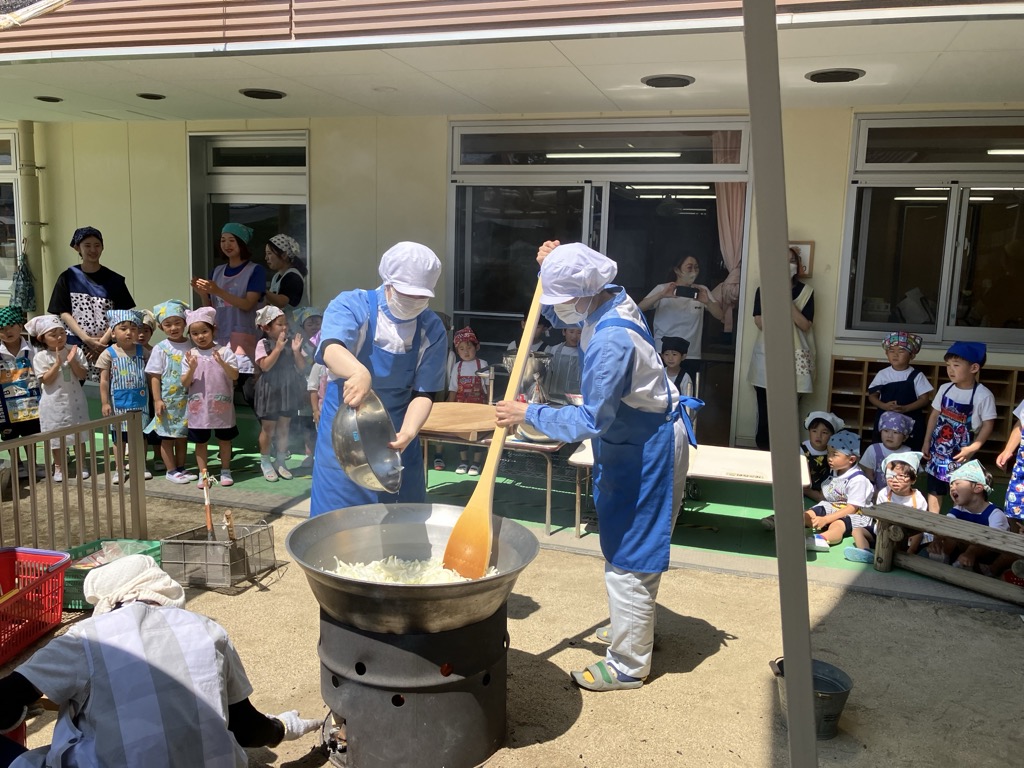大鍋でカレー作りを見る子ども達