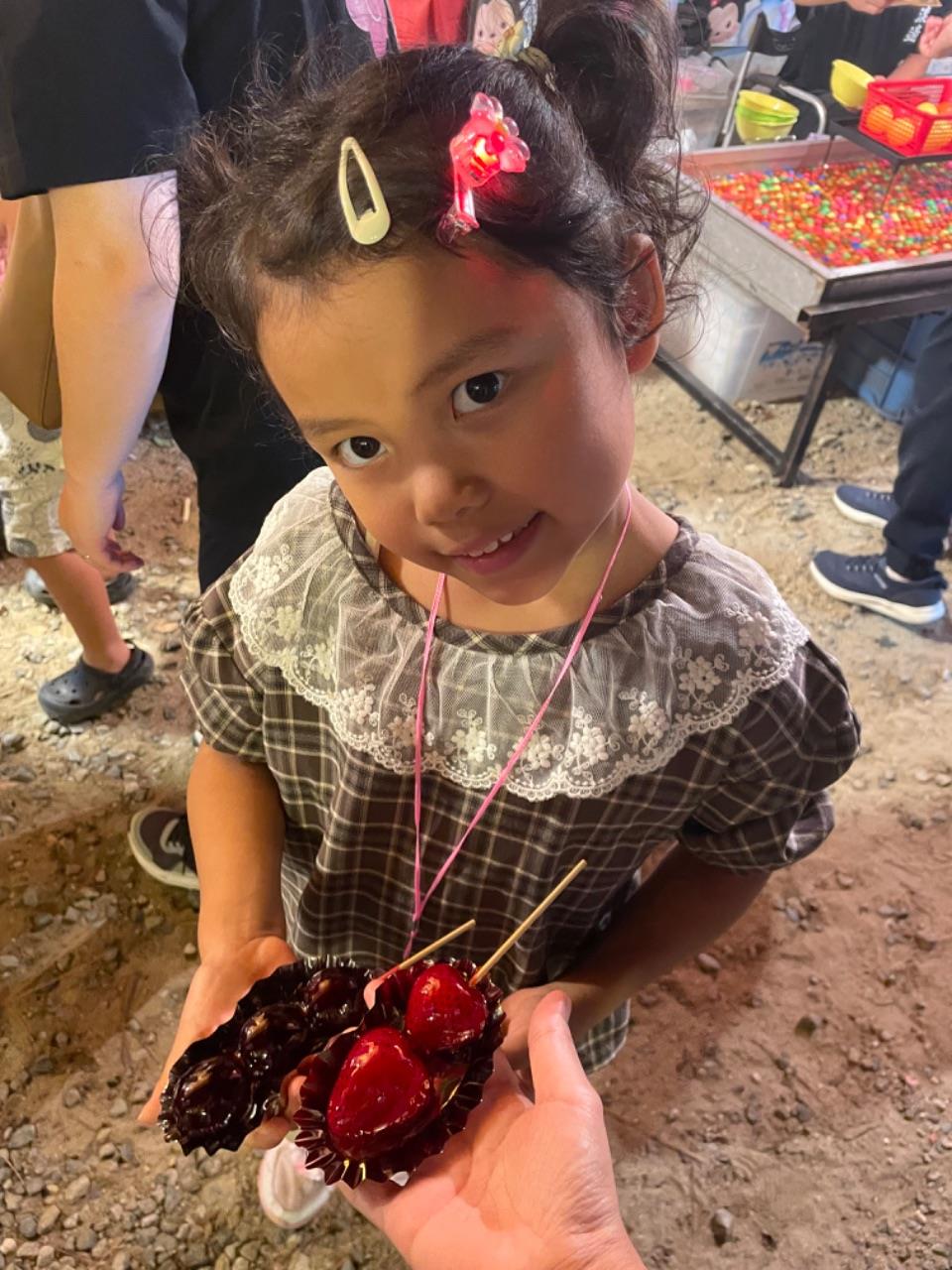 フルーツ飴を持っているお子さんの写真