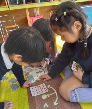 めくったカードの数字が一緒かどうかみんなで確かめています。