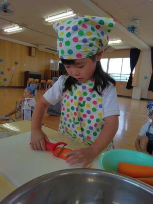 ピーラーで皮をむいている